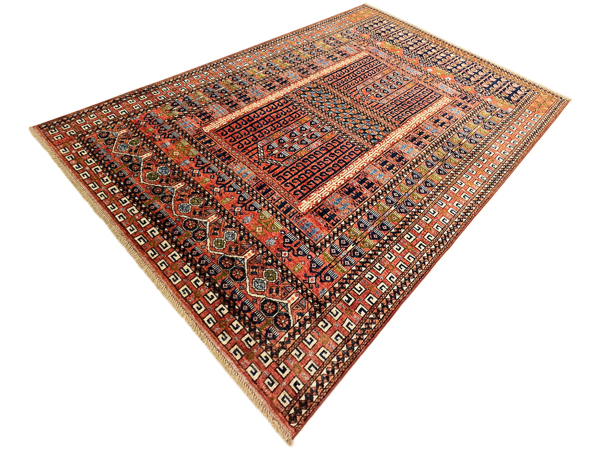 Turkmen-style rug with red and rust central panel, navy accents, and beige border