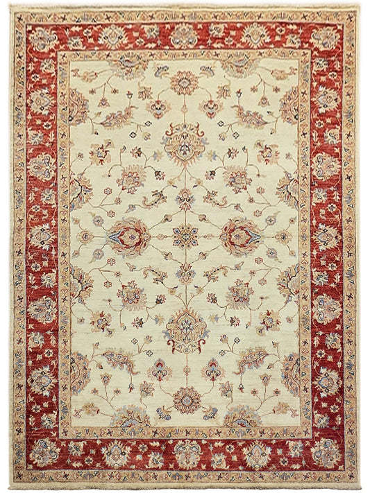 Cream and red patterned area rug with framed medallions and decorative border detailing.