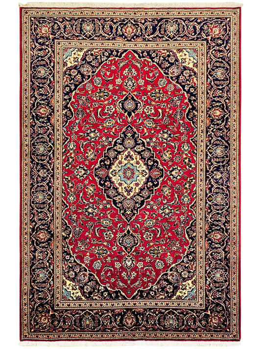 Kashan rug full view, red field with central diamond medallion and navy floral border
