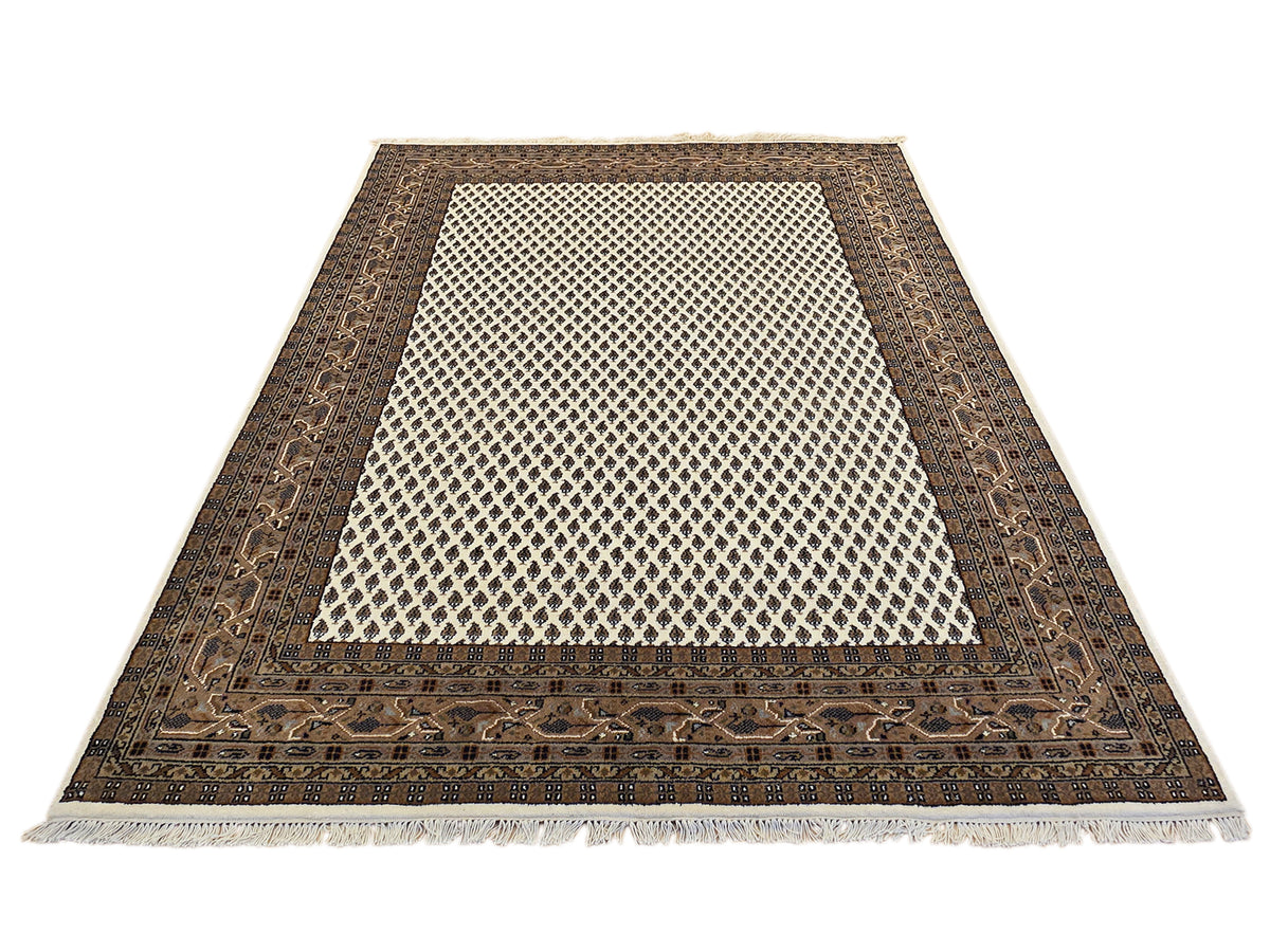 Rectangular rug with dark border, cream lattice center, and short fringed edges