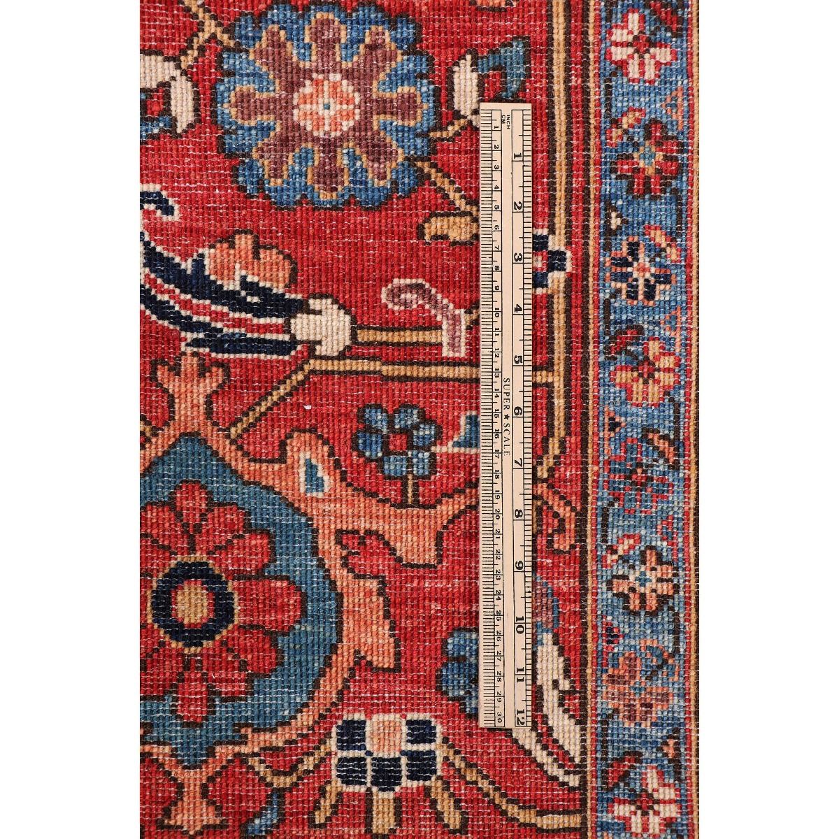 Chobi rug close-up with multicolor floral and geometric pattern in red and blue
