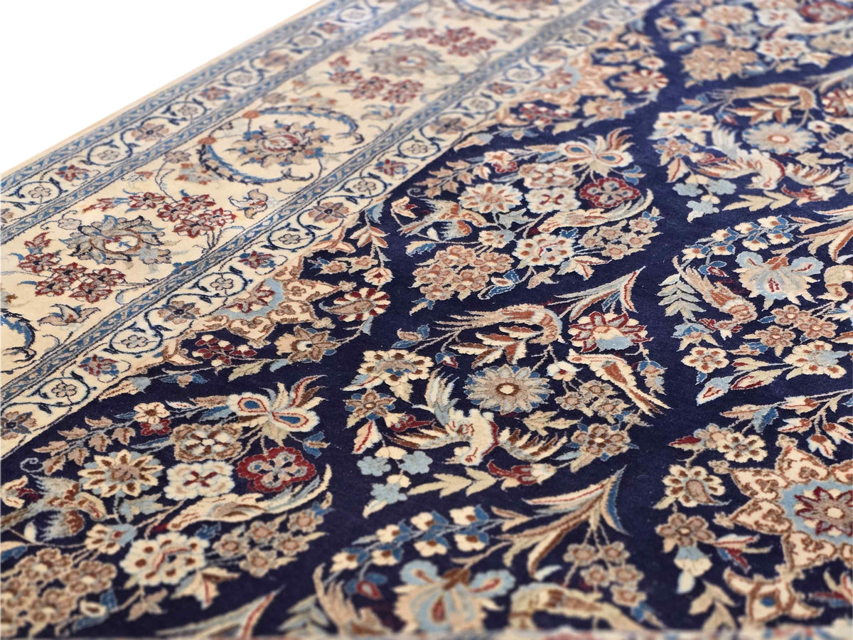 Close-up of navy and cream floral rug pattern with detailed medallion and corner motifs